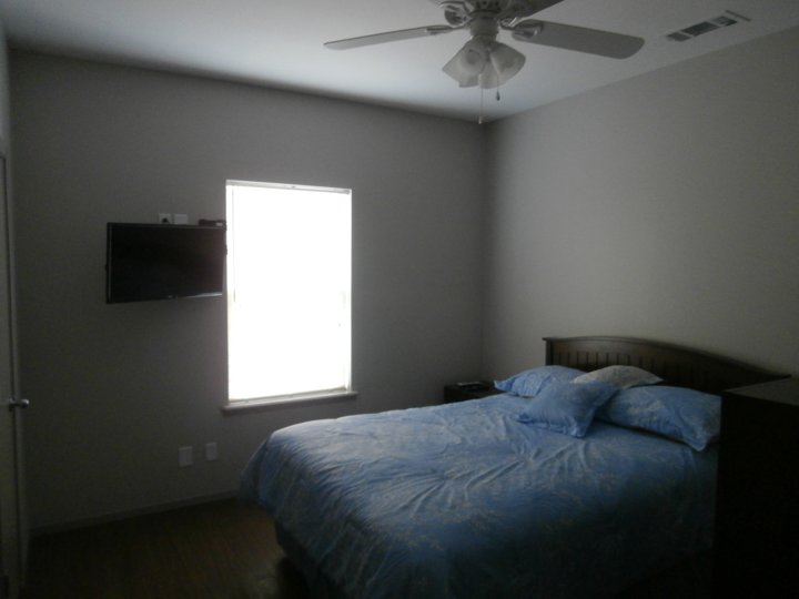 Furnished bedroom with bed and television